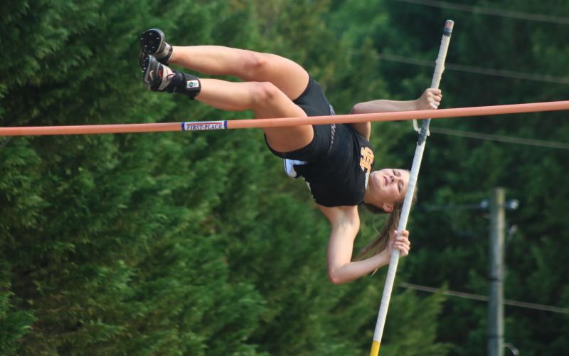 Sunshot from file - Hart County Freshman Amelia Johnson plunges herself into the air to clear the bar in the pole vault event on Tuesday, April 13 for senior night at Hart County High School. She earned eighth place at the Wingfoot Night of Champions.