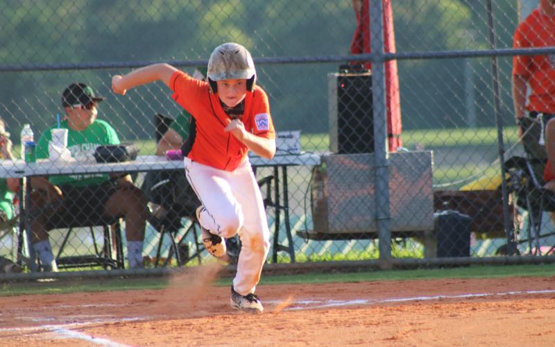 Sunshot from file - In a 2018 Little League All-Star tournament game, Kanyon Coulter sprints to first base after smacking a hit in the District 7 tournament where the Bulldogs earned first place.