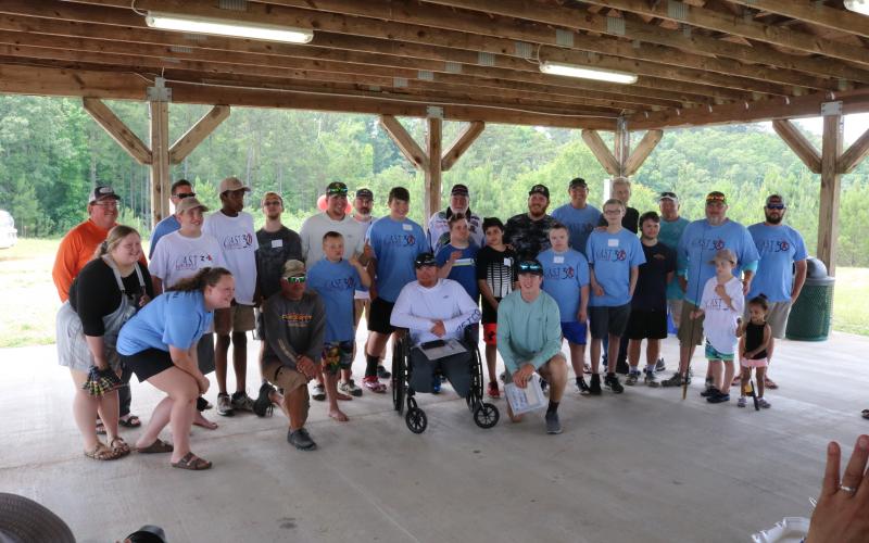 Sunshot by Grayson Williams - Participants and volunteers for Lake Hartwell’s first-ever CAST for Kids event pose for a photo after an awards ceremony on Saturday, June 6 at Gum Branch Mega Ramp in Hartwell.