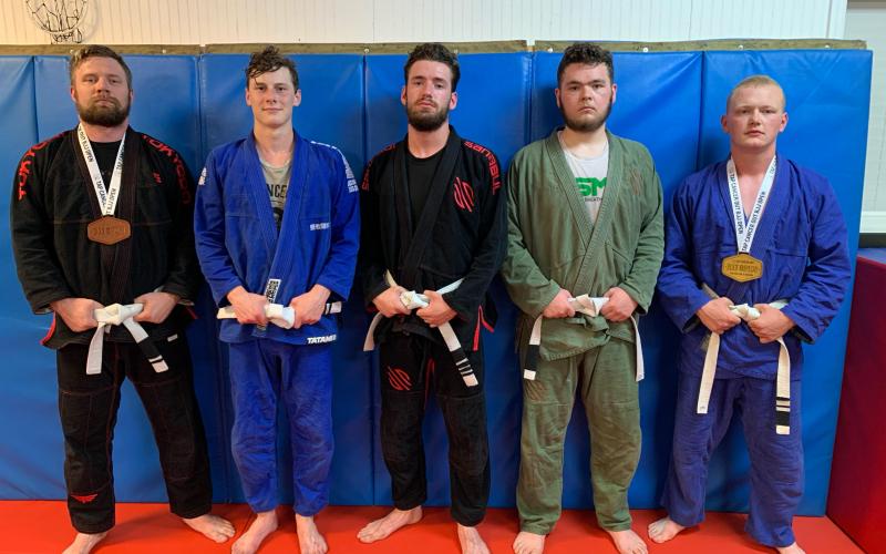 Photo submitted - Local jiu jitsu fighters, pictured from left to right, Chris Burns, Luke Didier, Jared Carswell, Chandler Howell and Alex Maxwell, all competed at and raised money for the Tap Cancer Out Brazilian Jiu Jitsu tournament on May 22 in Atlanta.