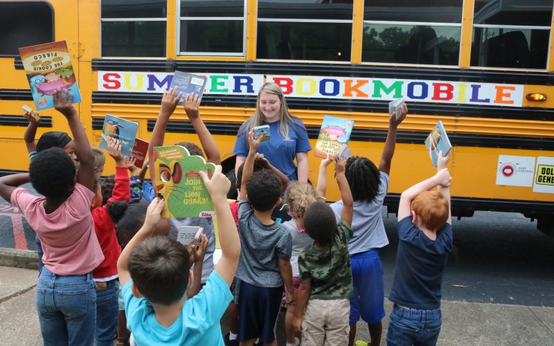 Grayson Williams/The Hartwell Sun - A crowd of students line up at Hart County Headstart on Richardson Street on June 8 to receive free books from the annual Summer Bookmobile put on by Hart Partners.