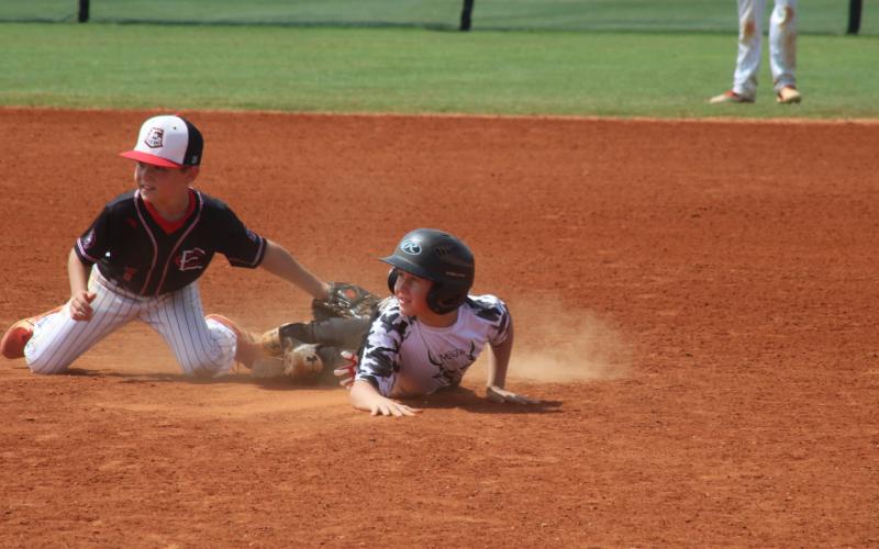 Sunshots by Grayson Williams - Above, Northeast Georgia Goat member Nolan Gibson slides into second base and looks to the umpire for the call on Saturday, June 6 at a USSSA Travel Baseball tournament in Hartwell