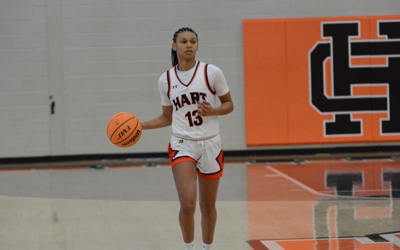 Junior guard Alexis Walker brings the ball up the court.