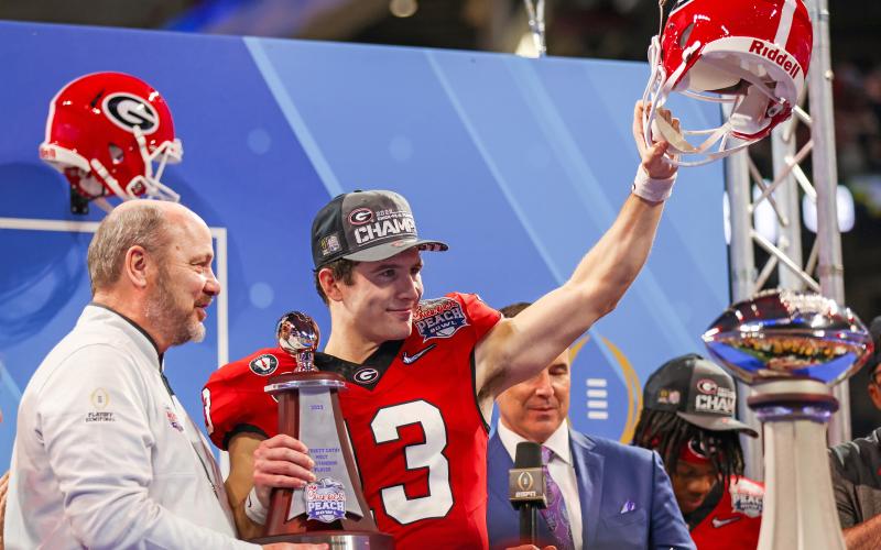 From a walk-on quarterback to a Heisman finalist, Stetson Bennett has already had a legendary UGA career. Leading the Bulldogs to a come-from-behind victory over Ohio State’s Buckeyes in the New Year’s Eve Peach Bowl, No. 13 was honored as the Most Valuable Player (MVP) on offensive. Making the presentation was Chick-fil-A Peach Bowl president and CEO Gary Stokan. Counting last year’s semifinal and national championship games—plus the SEC championship game—that makes four times the six-year senior has been 