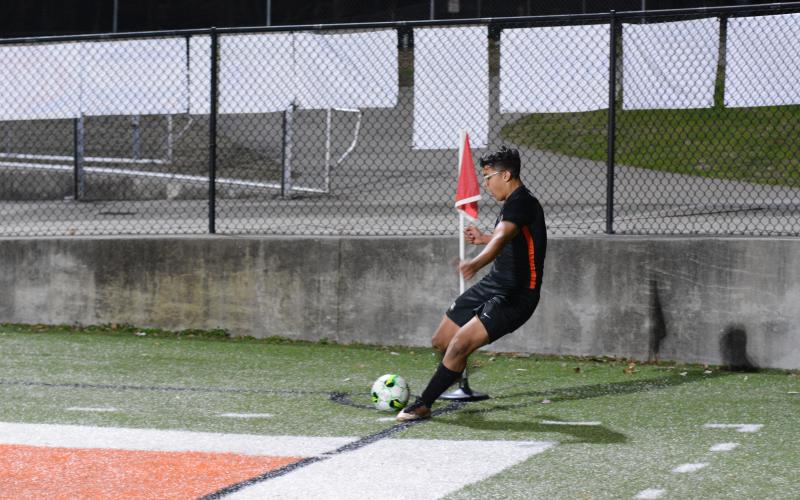 Junior left-back Fabian Rodriguez-Escobedo sends the corner kick into the box for a potential score in the Soccer Dogs home win against Towns County on Tuesday, Feb. 14.