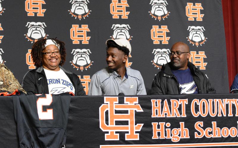 Pictured left to right: Davis’ mother, Dannette, senior wide receiver Paul Davis, and father William decked out in Akron Zips gear as Davis commits to Akron on National Signing Day.