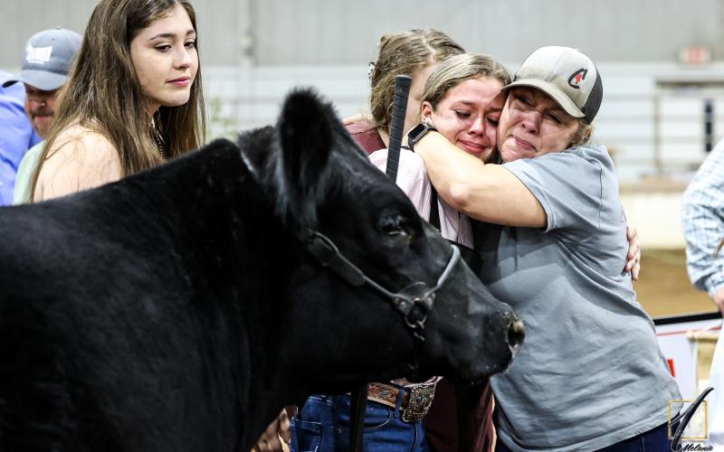 Ashlyn Floyd, and her mother, Rebecca Floyd, embrace after Ashlyn had two heifers both place in the top-5 overall at the Georgia State Livestock Show in Perry.