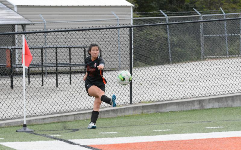 Pictured is senior forward Honor Chiang crossing the ball in as she scored four goals in the 9-0 win on senior night versus Athens Christian on March 31.