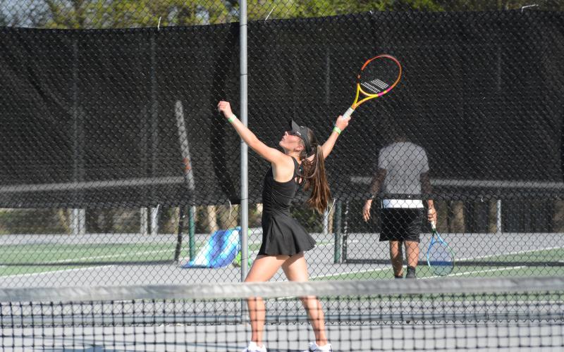 Pictured is senior Ryleigh Jordan setting up to serve as both boys and girls teams fall 4-1 to Franklin County in the first round of the region tournament on Tuesday.