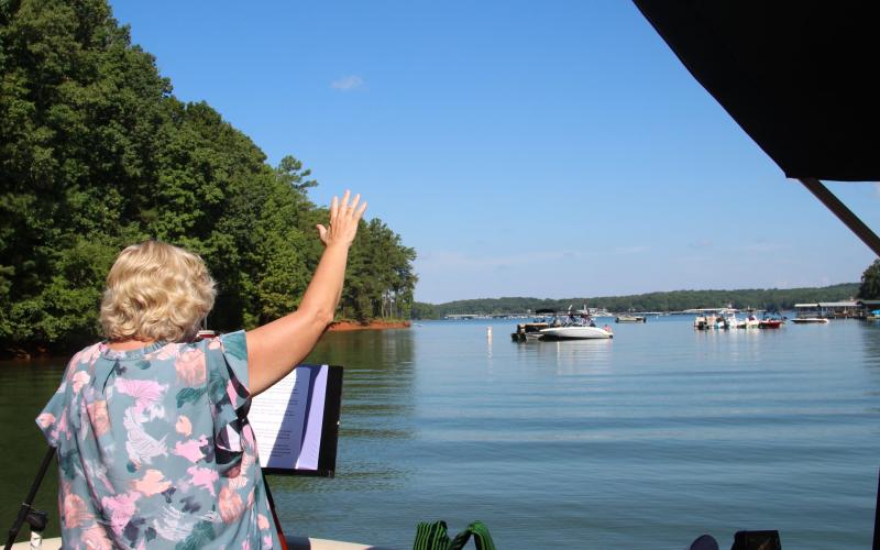 Worship leader Sherry Lewis is shown speaking at one of the services held during the first season of Water’s Edge Ministry at Lake Hartwell. 