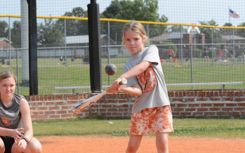 Nora Gibbs (right) focused on making contact with the ball during the 2023 Lady Bulldog’s softball camp.