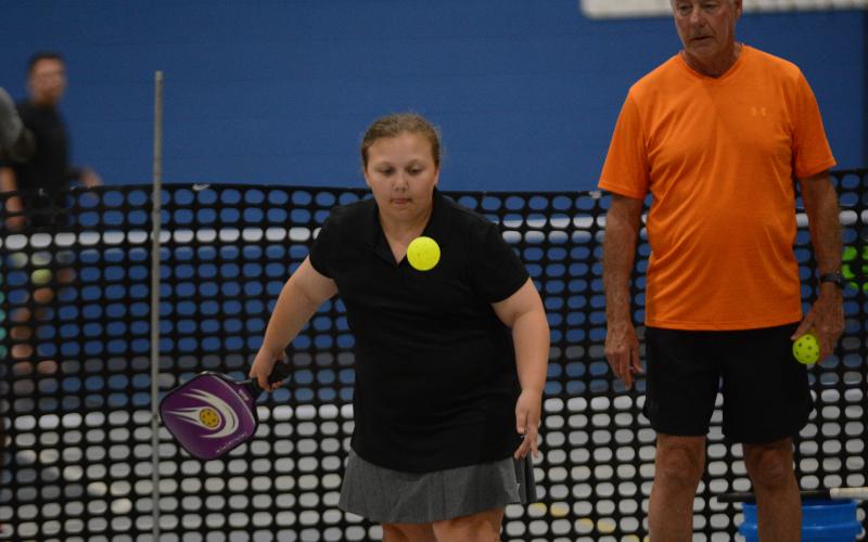 Gracie Driver (left) returns a serve at the youth pickleball camp hosted by the Bell Family YMCA on July 24-28.
