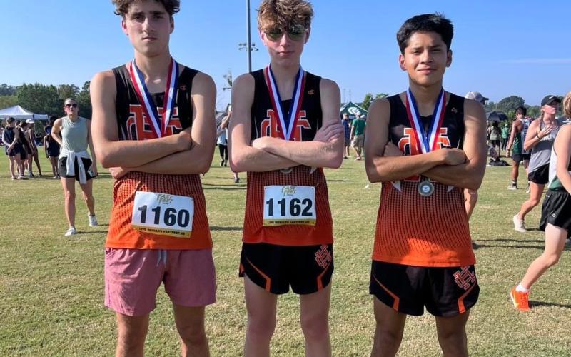 Pictured from left is Nate Harris, Braydon Lane, and Luis Genchi as they placed in the Top 20 to propel the boys team to a fifth place overall finish in the North Georgia Championships Aug.26 in Jefferson.
