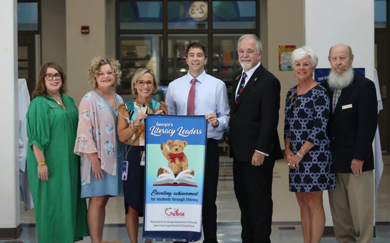 State School Superintendent Richard Woods, pictured third from right, presented North Hart Elementary School with a Literacy Leader banner on September 19, 2023. Pictured, from left to right, are Hart County Board of Education Chair Kim Pierce, Hart County Superintendent Jennifer Carter, NHES Principal Christina Weir, NHES Assistant Principal Marion Hanahan, State School Superintendent Richard Woods, Hart County Board of Education member Henley Cleary, and Hart County Board of Education member Dennis Dowell