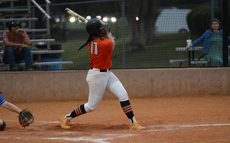 Senior infielder Jazz Shealer hits a hard hit ground ball down the third base line to bring home the tying run from first base in the 7-3 road lost to the Lady Warriors of Oconee County.