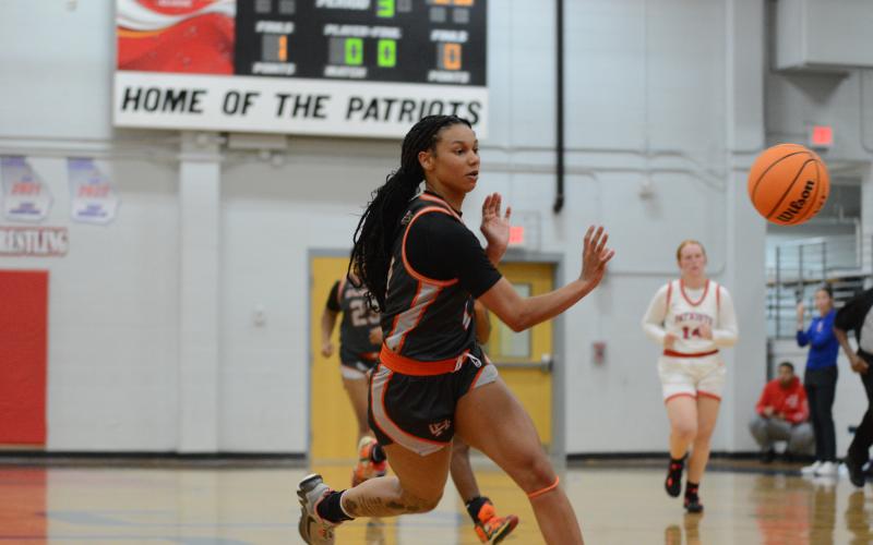 Pictured is senior forward Alexis Walker dishing the ball off to a teammate.