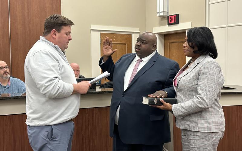 Rev. Richard Sheller (center) was sworn in to his new position as a Hartwell City Council member. The oath was administered by City Manager Jon Herschell (left) with Sheller’s wife Judy (right) holding the Bible.