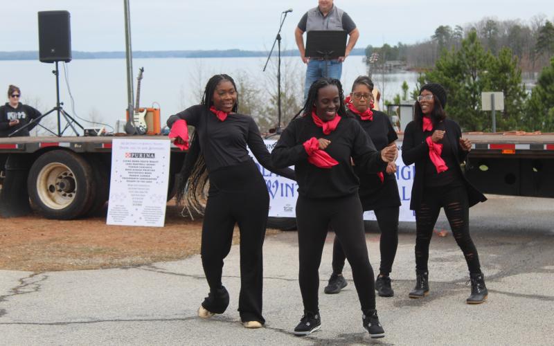 The Purinettes from Purina featuring Cheryl Kraemer, Shekova Allen, Pervasia Hardman, and Aretha Hall perform their TikTok style dance as city manager Jon Herschell who served as the judge for the event looks on. The Purinettes won the award for most entertaining dance mob.