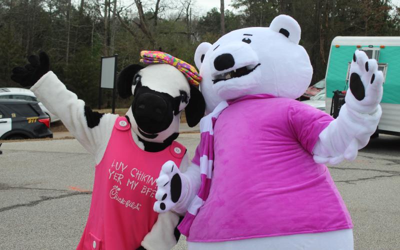 The cow from Chick-Fil-A in Lavonia poses with the Purina Polar Bear.