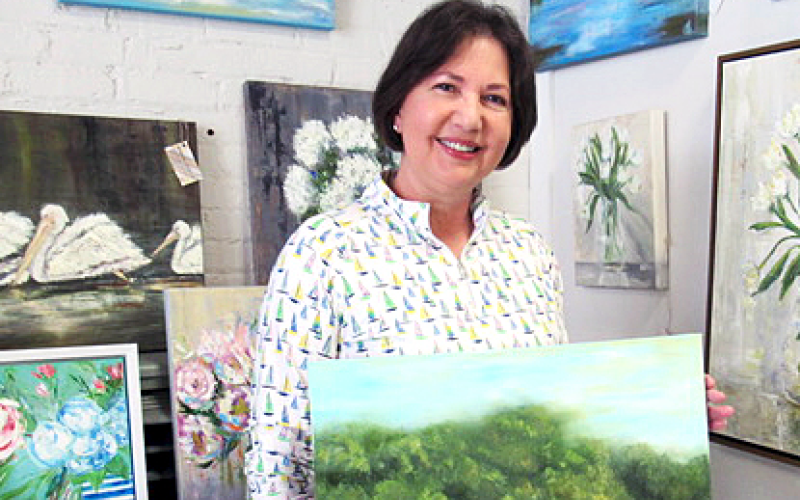 Angie Short posing with her favorite painting from her oeuvre. Photo by Rachel Black.