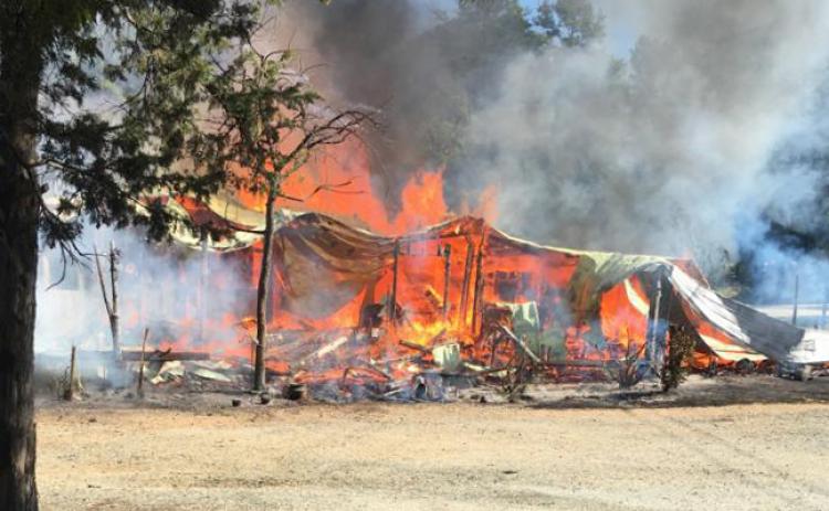 Photo submitted -- The Lake House Tavern is engulfed in flames Saturday morning on Rock Springs Road in Hart County.