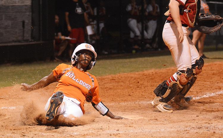 Sunshot by Grayson Williams — Hart County’s Red Campbell slides into home to score in the bottom of the sixth inning on Aug. 15 against Morgan County.