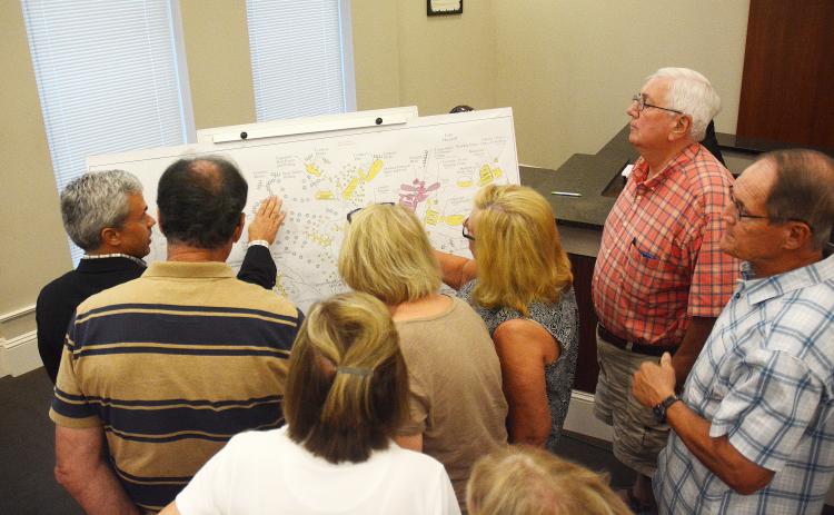 Sunshot by Michael Hall — A group of audience members gather during an executive session at the Sept. 9 Hartwell City Council meeting to learn details from consultant Shawn Davis, far left, of the proposed project to rethink Hart State Park. 
