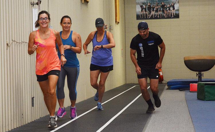 Sunshot by Michael Hall -- Julie George, left, Julie Boleman, second from left, Kay Ankerich, second from right a Andrew Wilder, right, start the first heat of the Honor the Heroes Fitness Challenge on Labor Day at the Bell Family YMCA.