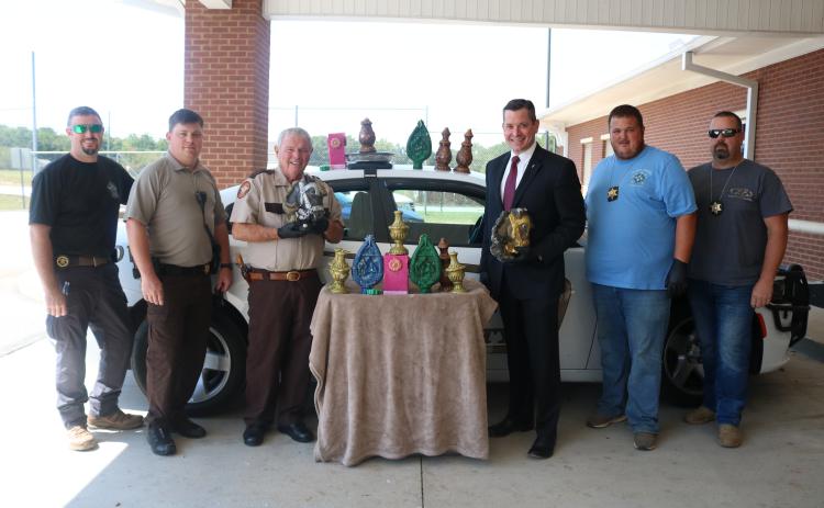 Sunshot by Grayson Williams — Pictured from left to right are, Inv. Chris Carroll, deputy Josh Fowler, Sheriff Mike Cleveland, District Attorney Parks White, Inv. Kevin White and Inv. Joseph Haley with 47 pounds of methamphetamine disguised as candles.