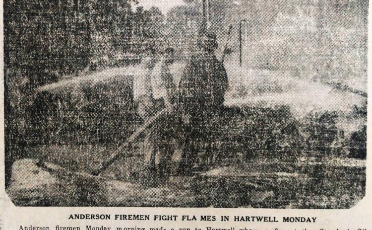 In this faded image on newsprint, Anderson firefighters fight a fire in Hartwell at the Standard Oil Company in 1944. 