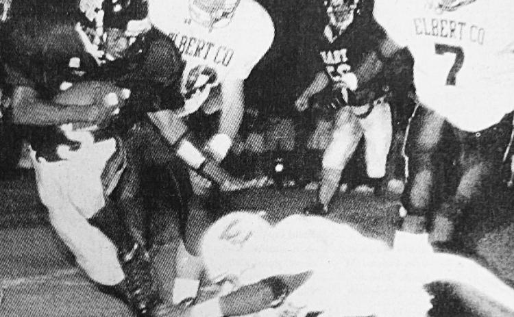 File photo Tino Stowers evades an Elbert County tackler in the Bulldogs’ 7-3 win over their rival in 1999.