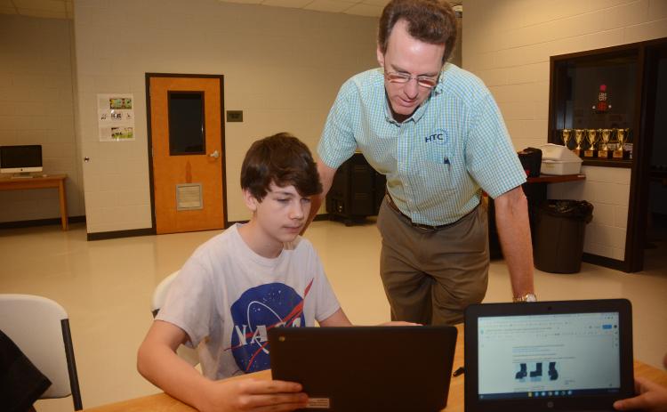 Sunshot by Michael Hall — Seventh-grader Wyatt Zimmerman, left, shows HTC president Randy Daniel his work recently at Hart County Middle School. HTC is a regular supporter of the Hart County Charter System. 