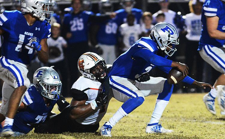 Hart County's Kaimon Rucker pulls down the Pierce County quarterback for a sack late in the game in Blackshear on Nov. 22 in the second round of the state playoffs. 