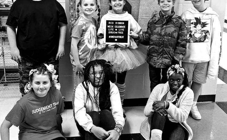 Hart County Middle School students wore “crazy socks and crazy hair” to show that from head to toe they are drugs and bully free. Pictured from left to right are, bottom row, Kimberly Lowney, Jo’niya Glaze, Brandi Harris, back row, Hayden Gunnels, Jacey Barnes, Aubrey Layman, Lance Shaffer, and Kaden Jacobson. 