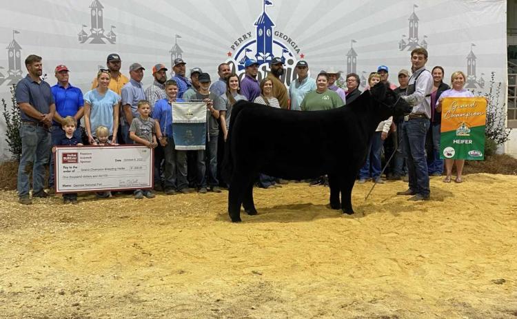 Pictured above at the 2022 Georgia National Fair Livestock Show is Hart County High School student Trey Chafin with his Grand Supreme heifer, which made him champion among 500 statewide competitors.   
