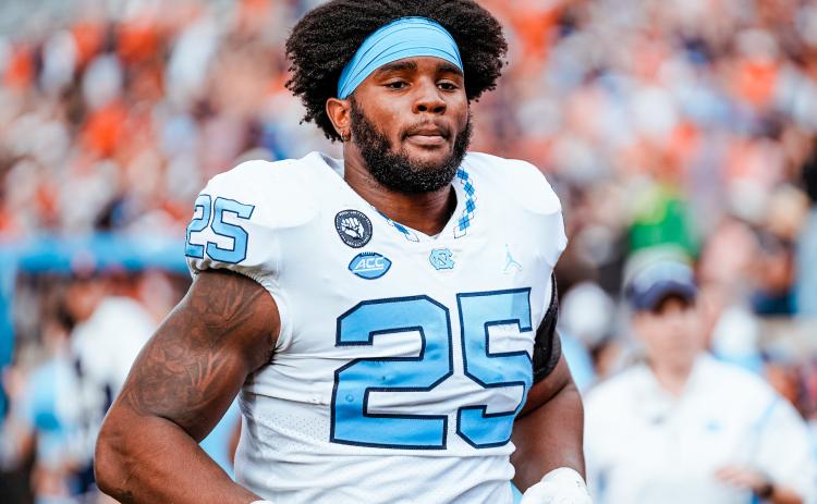 North Carolina Tar Heel Kaimon Rucker trots onto the field before a 36-34 win over Wake Forest which clinched the Coastal Division and an appearance in the ACC Championship vs. Clemson.  