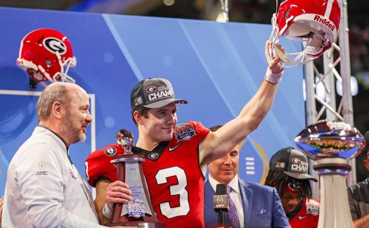 From a walk-on quarterback to a Heisman finalist, Stetson Bennett has already had a legendary UGA career. Leading the Bulldogs to a come-from-behind victory over Ohio State’s Buckeyes in the New Year’s Eve Peach Bowl, No. 13 was honored as the Most Valuable Player (MVP) on offensive. Making the presentation was Chick-fil-A Peach Bowl president and CEO Gary Stokan. Counting last year’s semifinal and national championship games—plus the SEC championship game—that makes four times the six-year senior has been 