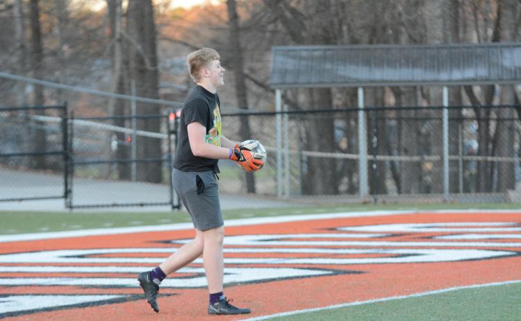 Junior goalkeeper Ayden Thomason gets ready to send the ball down field as the soccer Dogs prepare for their season opener on the road versus Cedar Shoals on Friday, Jan. 27.