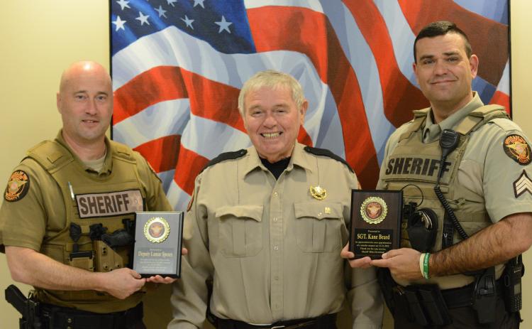 Hart County deputy Lamar Spears (left) and Sgt. Kane Beard (right) are awarded plaques from sheriff Mike Cleveland for their roles in the arrest of Andrew Nicholas Berry, who is accused of killing his girlfriend on Dec. 31.