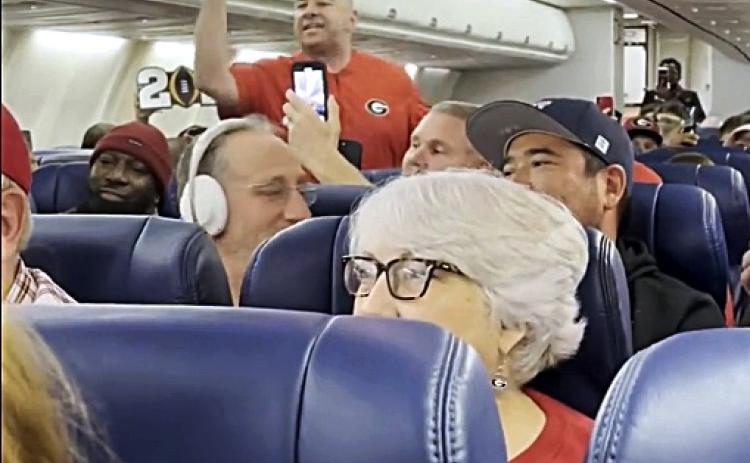 Pictured is a screencap of a video taken of Hartwell resident Brooks Mewborn, who went viral for the scene above, where he started a UGA chant on a plane hours after the school’s second consecutive national championship.   