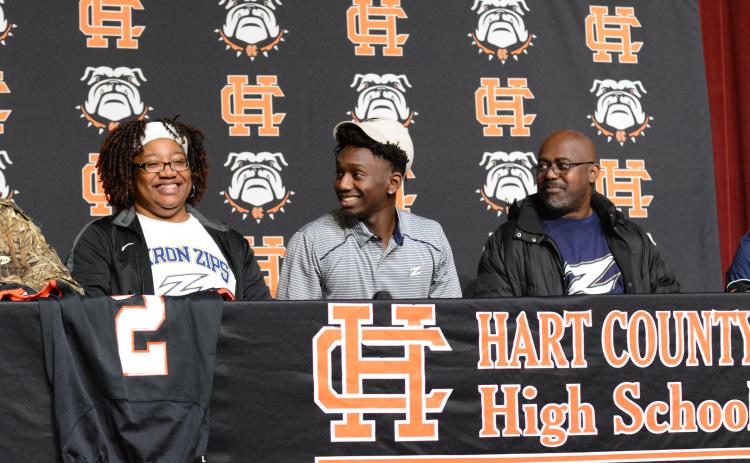 Pictured left to right: Davis’ mother, Dannette, senior wide receiver Paul Davis, and father William decked out in Akron Zips gear as Davis commits to Akron on National Signing Day.