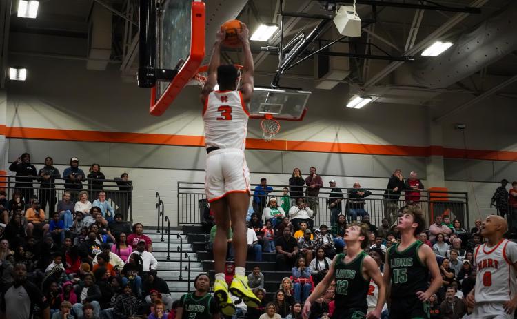 Senior Tahj Johnson rises above the rim to slam it home as he led the Dogs with 18 points in Hart County’s  win over the Franklin County Lions, 73-60 at home on senior night. (Photo by Lexie Wheless)