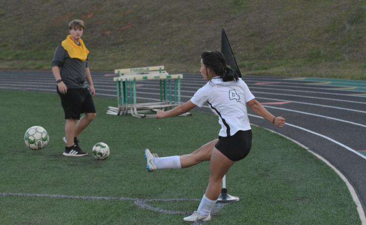 Pictured is senior forward Honor Chiang as she scores a hat-trick.