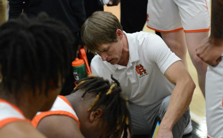 Dogs head coach Matt Gibbs draws up a play during a home game from earlier in the season.