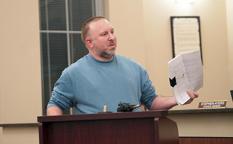 Hartwell resident and Franklin Springs Police Chief Kevin Thompson holds up a “15-page memo,” which discusses complaints about Parkdale Drive. Thompson claimed the memo contained unnecessary personal information about him, including his place of employment and title.