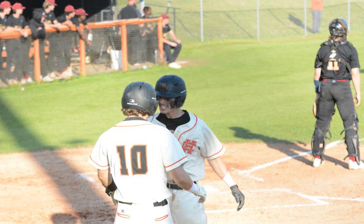 Junior Zack Dombrowsky (10) and senior Jordan Leach celebrated as the Diamond Dogs swept Washington-Wilkes at home on April 13, by scores of 7-6 and 10-6.