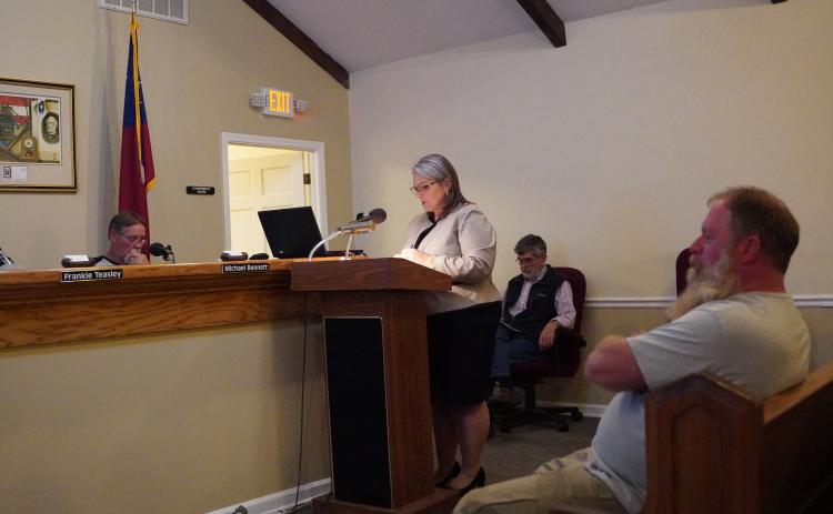 County attorney Kim Higginbotham reads the rules regarding public comment to the Hart County Board of Commissioners during Tuesday’s meeting while Jim Gaines (right) listens on. 