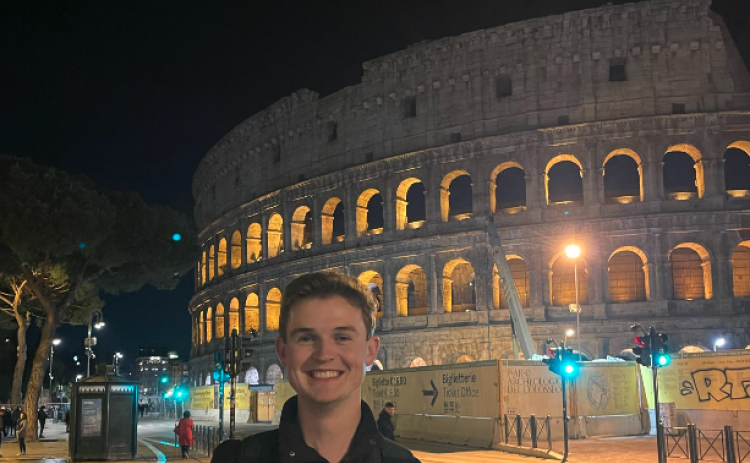 Dawson Baker stands in front of the Colosseum in Rome, Italy during Easter weekend. The Colosseum was constructed during the first century A.D.   