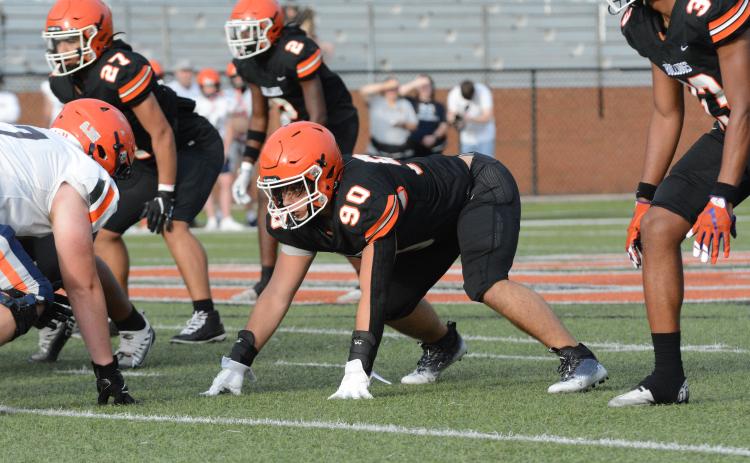 Rising senior defensive end Harley Harris (90) gets set in his stance and awaits the snap in the 2023 spring game versus Habersham Central on Friday, May 19.