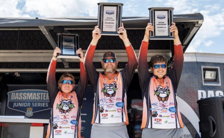 Pictured from left to right Kale Temple, boat captain Isaac Temple, and Luke Schnell hoisting up their Bassmaster Junior National Championship trophies during the awards ceremony on  Saturday, July 22 on Lake Hartwell. They also received a $2,000 scholarship during the ceremony as well. (Photo by Logan Crumley, Bassmaster)